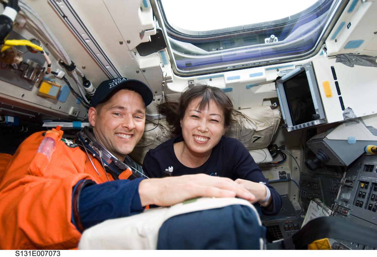 S131-E-007073 (5 April 2010) --- NASA astronaut James P. Dutton Jr., STS-131 pilot; and Japan Aerospace Exploration Agency (JAXA) astronaut Naoko Yamazaki, mission specialist, are pictured on the aft flight deck of space shuttle Discovery during postlaunch activities.