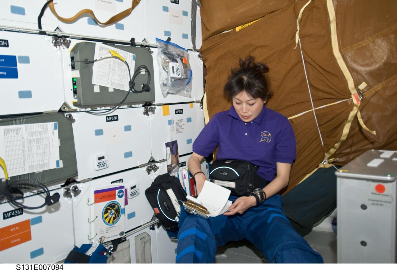 S131-E-007094 (6 April 2010) --- Japan Aerospace Exploration Agency (JAXA) astronaut Naoko Yamazaki, STS-131 mission specialist, works on the middeck of space shuttle Discovery during flight day two activities.