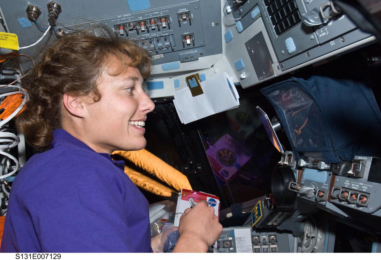 S131-E-007129 (6 April 2010) --- NASA astronaut Dorothy Metcalf-Lindenburger, STS-131 mission specialist, is pictured on the flight deck of space shuttle Discovery during flight day two activities.