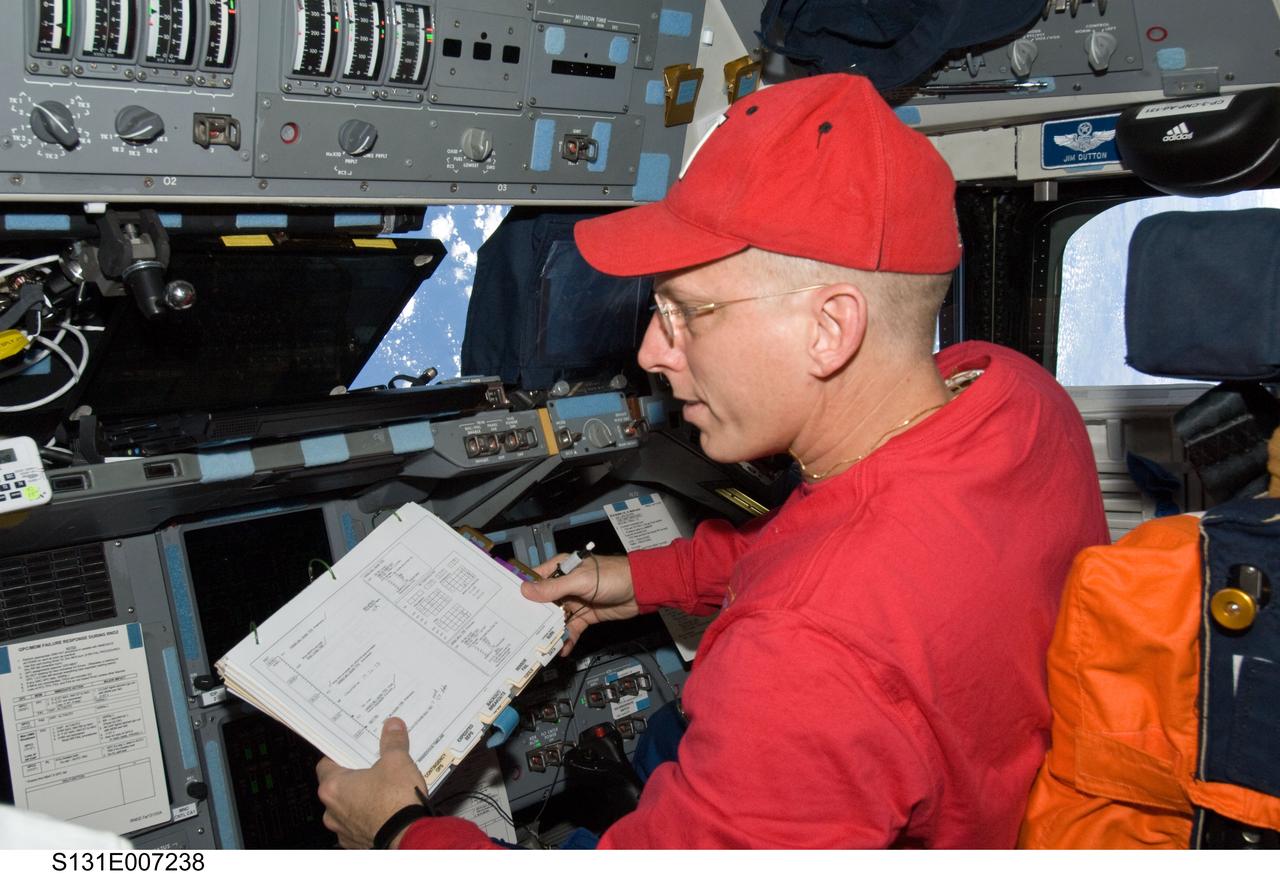 S131-E-007238 (7 April 2010) --- NASA astronaut Clayton Anderson, STS-131 mission specialist, occupies the pilot?s station on the forward flight deck of space shuttle Discovery during flight day three activities.