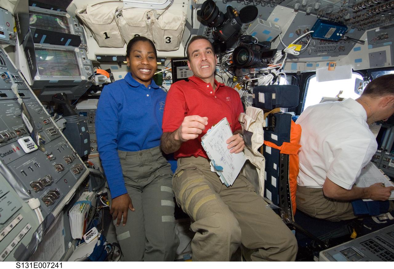 S131-E-007241 (7 April 2010) --- NASA astronauts Stephanie Wilson and Rick Mastracchio, STS-131 mission specialists; along with James P. Dutton Jr. (right), pilot, are pictured on the flight deck of space shuttle Discovery during flight day three activities.