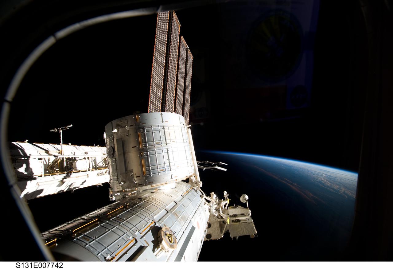 S131-E-007742 (7 April 2010) --- Backdropped by the blackness of space and Earth?s horizon, the Japanese Kibo complex of the International Space Station is featured in this image photographed by an STS-131 crew member while space shuttle Discovery remains docked with the station.