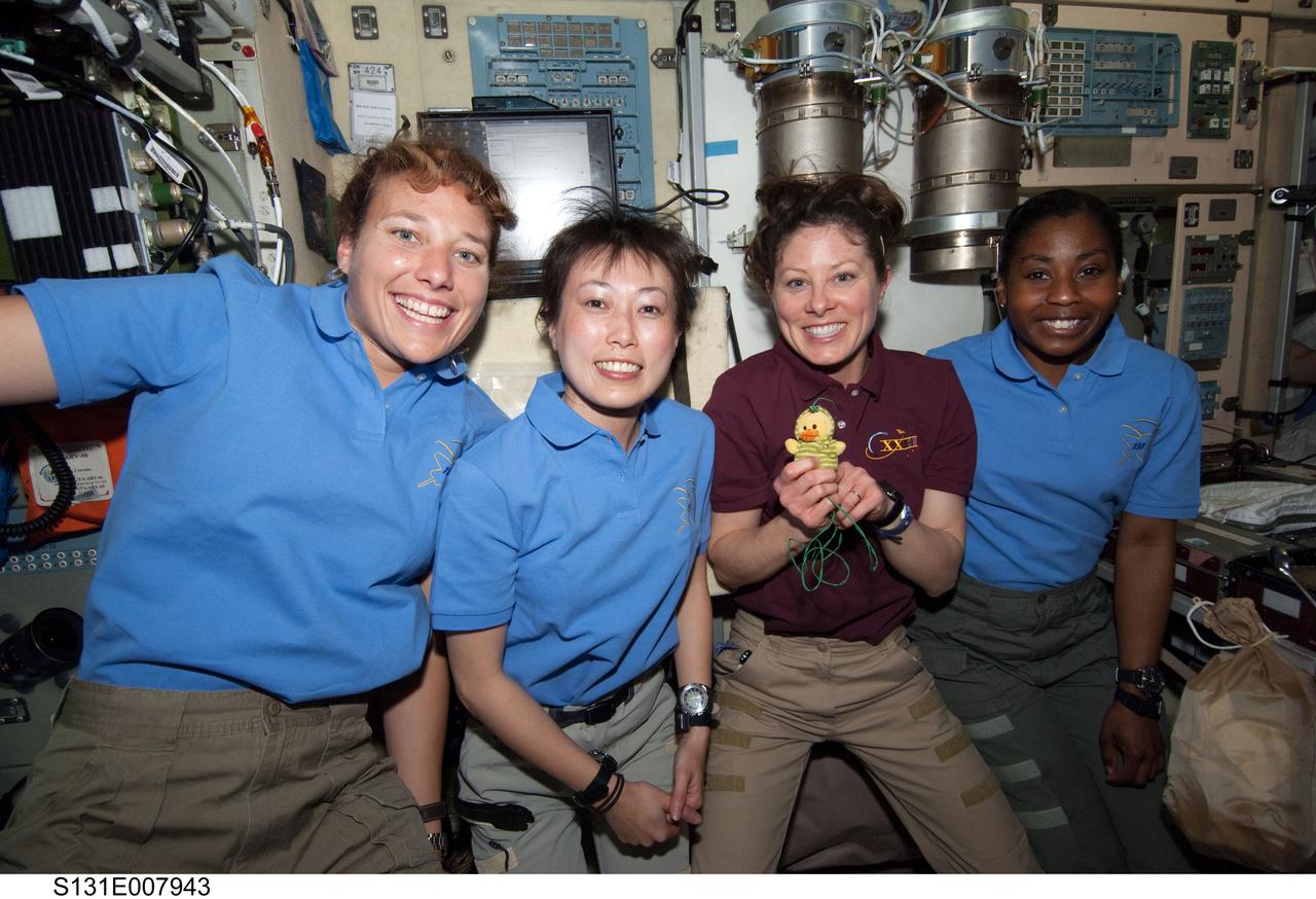 S131-E-007943 (7 April 2010) --- The four women currently on the International Space Station pose for a photo in the Zvezda Service Module while space shuttle Discovery remains docked with the station. From the left are NASA astronaut Dorothy Metcalf-Lindenburger and Japan Aerospace Exploration Agency (JAXA) astronaut Naoko Yamazaki, both STS-131 mission specialists; along with NASA astronauts Tracy Caldwell Dyson, Expedition 23 flight engineer; and Stephanie Wilson, STS-131 mission specialist.