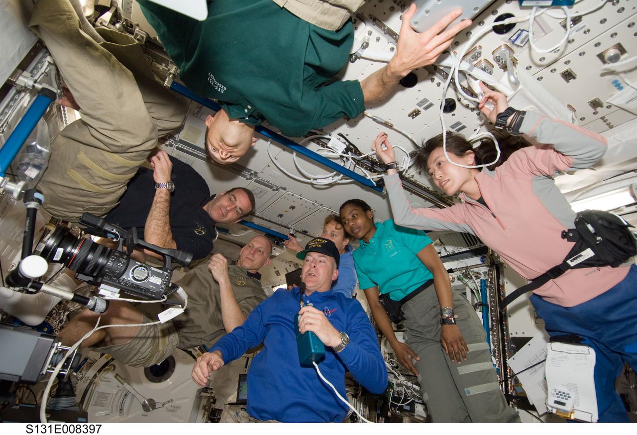 S131-E-008397 (9 April 2010) --- The seven STS-131 crew members -- working guests for several days aboard the International Space Station --  are seen in Japan's Kibo laboratory during a video downlink to the ground.  NASA astronaut Alan Poindexter is at bottom center. Others pictured are  astronauts James P. Dutton Jr. (top edge of frame), pilot; and Rick Mastracchio (from far left), Clayton Anderson, Dorothy Metcalf-Lindenburger and Stephanie Wilson, along with Japan's Naoko Yamazaki, all mission specialists.