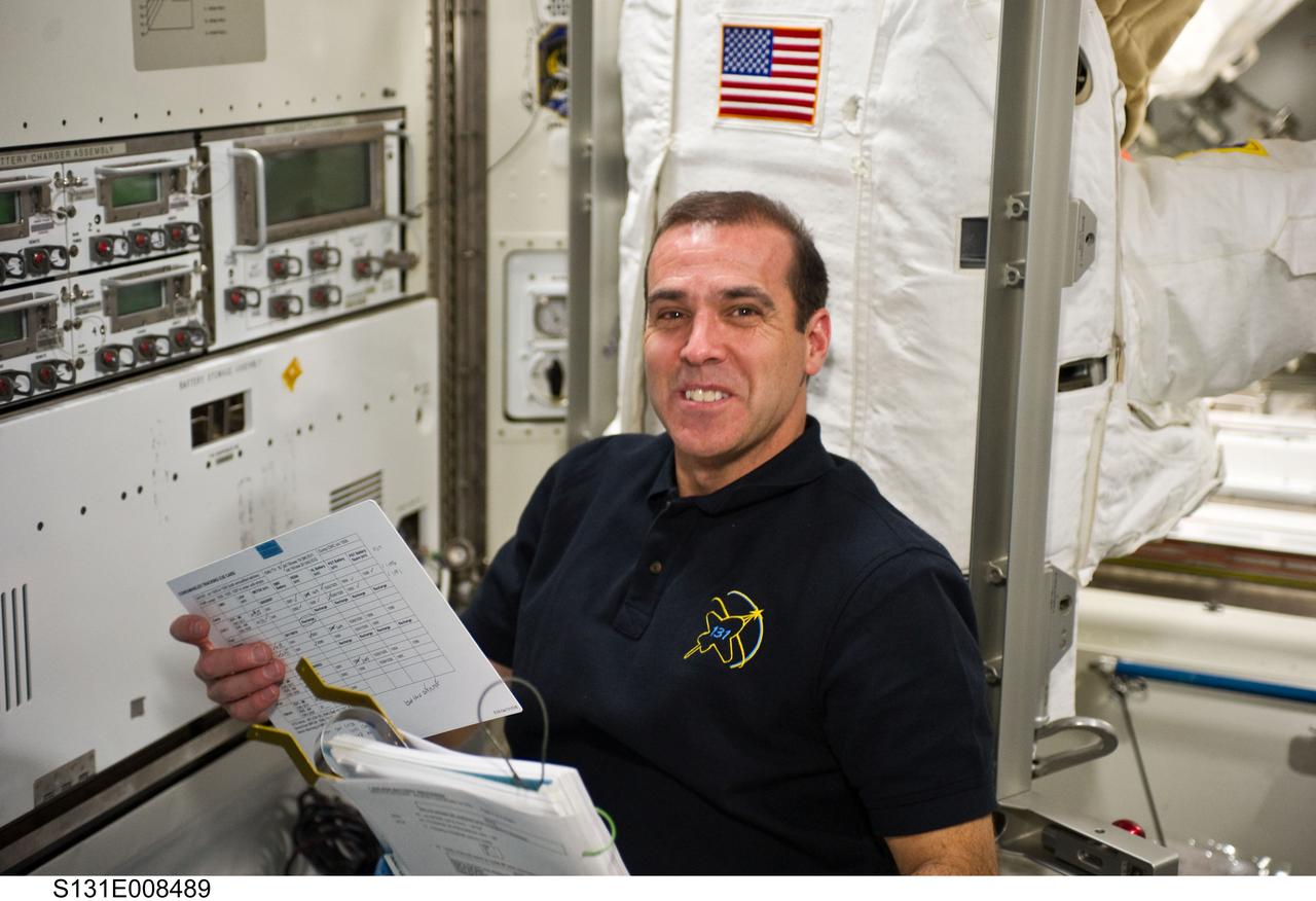 S131-E-008489 (10 April 2010) --- NASA astronaut Rick Mastracchio, STS-131 mission specialist, is pictured in the Quest airlock of the International Space Station while space shuttle Discovery remains docked with the station.