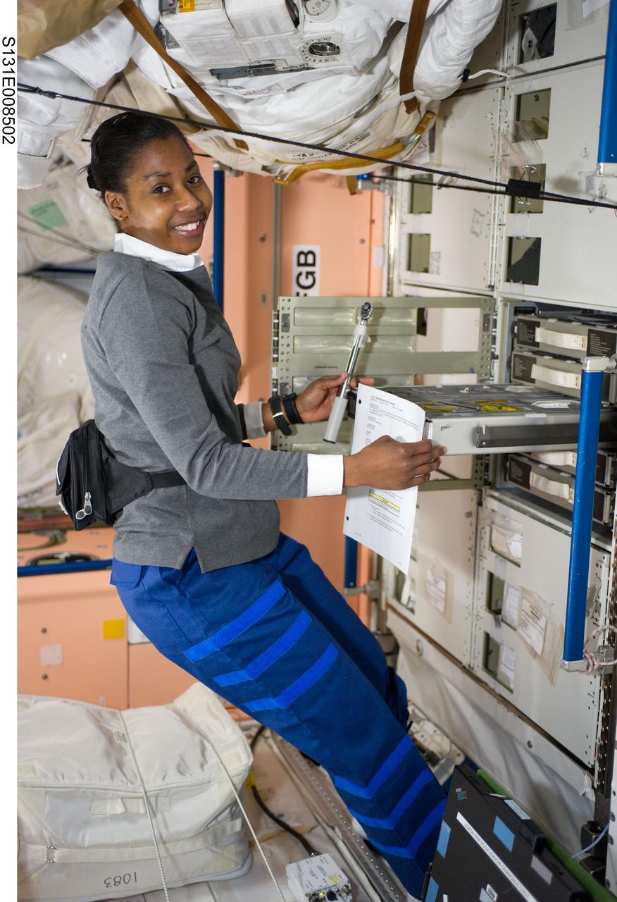 S131-E-008502 (10 April 2010) --- NASA astronaut Stephanie Wilson, STS-131 mission specialist, retrieves a tool from a drawer in the Unity node of the International Space Station while space shuttle Discovery remains docked with the station.
