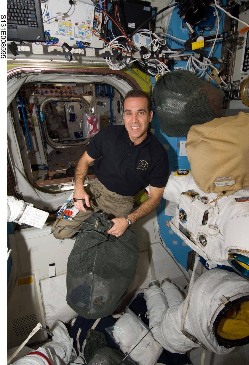 S131-E-008595 (10 April 2010) --- NASA astronaut Rick Mastracchio, STS-131 mission specialist, works in the Quest airlock of the International Space Station while space shuttle Discovery remains docked with the station.