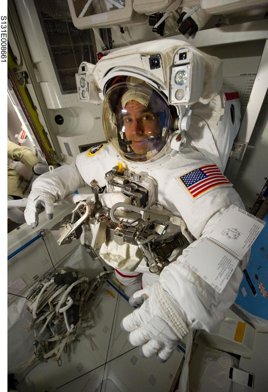 S131-E-008661 (11 April 2010) --- NASA astronaut Rick Mastracchio, STS-131 mission specialist, attired in his Extravehicular Mobility Unit (EMU) spacesuit, is pictured in the Quest airlock of the International Space Station prior to the start of the mission's second spacewalk.