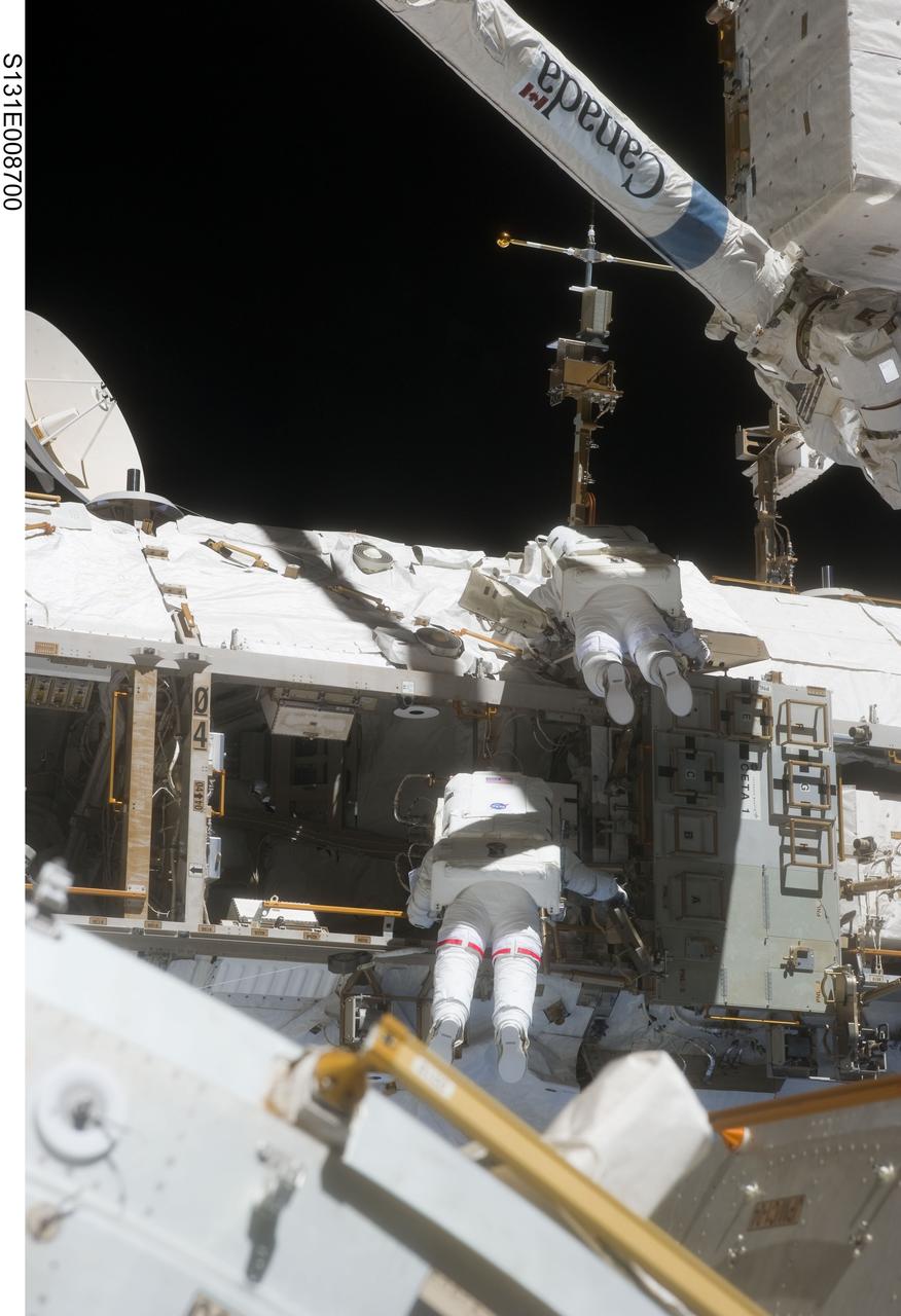 S131-E-008700 (11 April 2010) --- NASA astronaut Rick Mastracchio (bottom) and Clayton Anderson, both STS-131 mission specialists, participate in the mission's second session of extravehicular activity (EVA) as construction and maintenance continue on the International Space Station. During the seven-hour, 26-minute spacewalk, Mastracchio and Anderson unhooked and removed the depleted ammonia tank and installed a 1,700-pound ammonia tank on the station?s Starboard 1 truss, completing the second of a three-spacewalk coolant tank replacement process.