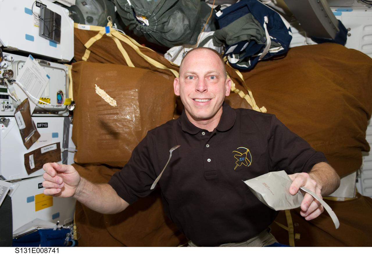 S131-E-008741 (11 April 2010) --- NASA astronaut Clayton Anderson, STS-131 mission specialist, is pictured on the middeck of space shuttle Discovery while docked with the International Space Station.