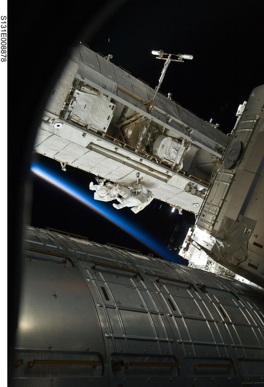 S131-E-008878 (11 April 2010) --- NASA astronauts Rick Mastracchio (left) and Clayton Anderson, both STS-131 mission specialists, participate in the mission's second session of extravehicular activity (EVA) as construction and maintenance continue on the International Space Station. During the seven-hour, 26-minute spacewalk, Mastracchio and Anderson unhooked and removed the depleted ammonia tank and installed a 1,700-pound ammonia tank on the station?s Starboard 1 truss, completing the second of a three-spacewalk coolant tank replacement process. The thin line of Earth's atmosphere appears in frame center.