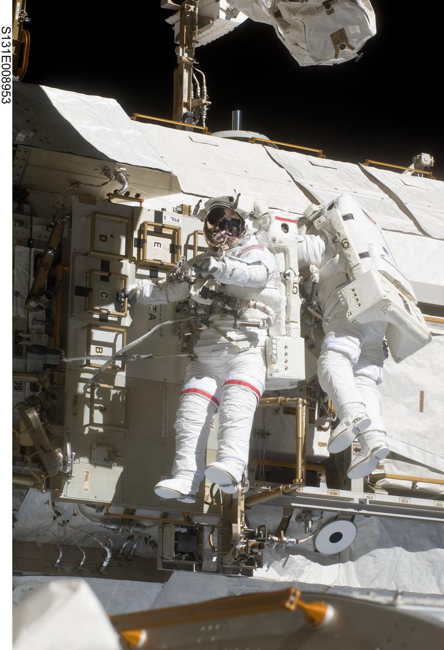 S131-E-008953 (11 April 2010) --- NASA astronauts Rick Mastracchio (left) and Clayton Anderson, both STS-131 mission specialists, participate in the mission's second session of extravehicular activity (EVA) as construction and maintenance continue on the International Space Station. During the seven-hour, 26-minute spacewalk, Mastracchio and Anderson unhooked and removed the depleted ammonia tank and installed a 1,700-pound ammonia tank on the station?s Starboard 1 truss, completing the second of a three-spacewalk coolant tank replacement process.