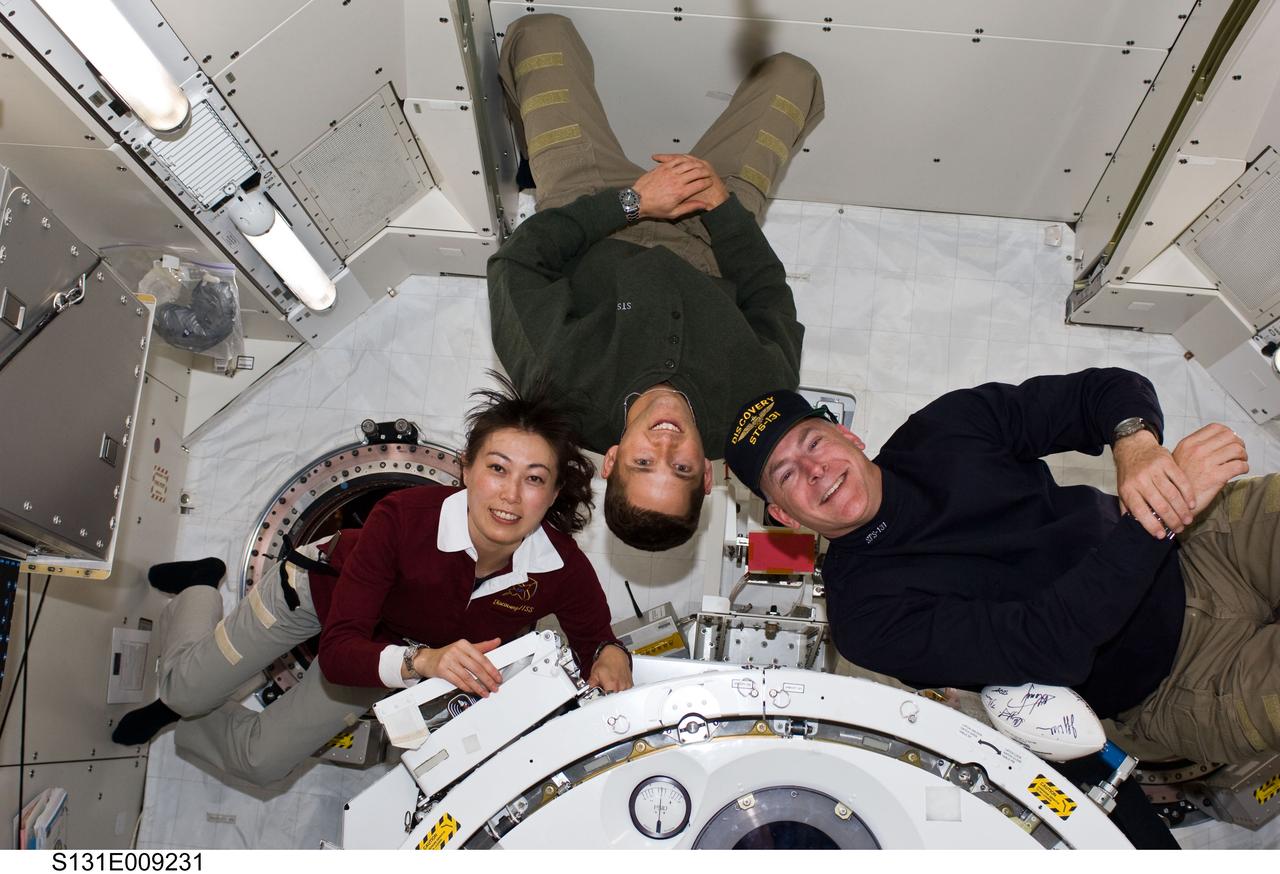 S131-E-009231 (12 April 2010) --- NASA astronauts Alan Poindexter (right) and James P. Dutton Jr., STS-131 commander and pilot, respectively; along with Japan Aerospace Exploration Agency (JAXA) astronaut Naoko Yamazaki, mission specialist, pose for a photo in the Kibo laboratory of the International Space Station while space shuttle Discovery remains docked with the station.