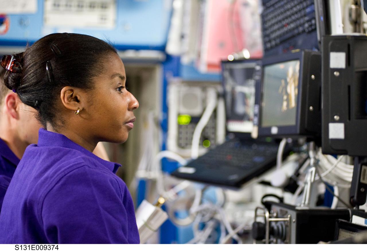 S131-E-009374 (13 April 2010) --- NASA astronaut Stephanie Wilson, STS-131 mission specialist, is pictured near a robotic workstation in the Destiny laboratory of the International Space Station while space shuttle Discovery remains docked with the station.