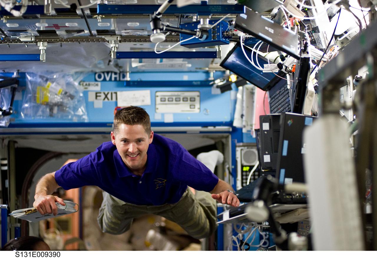 S131-E-009390 (13 April 2010) --- NASA astronaut James P. Dutton Jr., STS-131 pilot, floats freely in the Destiny laboratory of the International Space Station while space shuttle Discovery remains docked with the station.