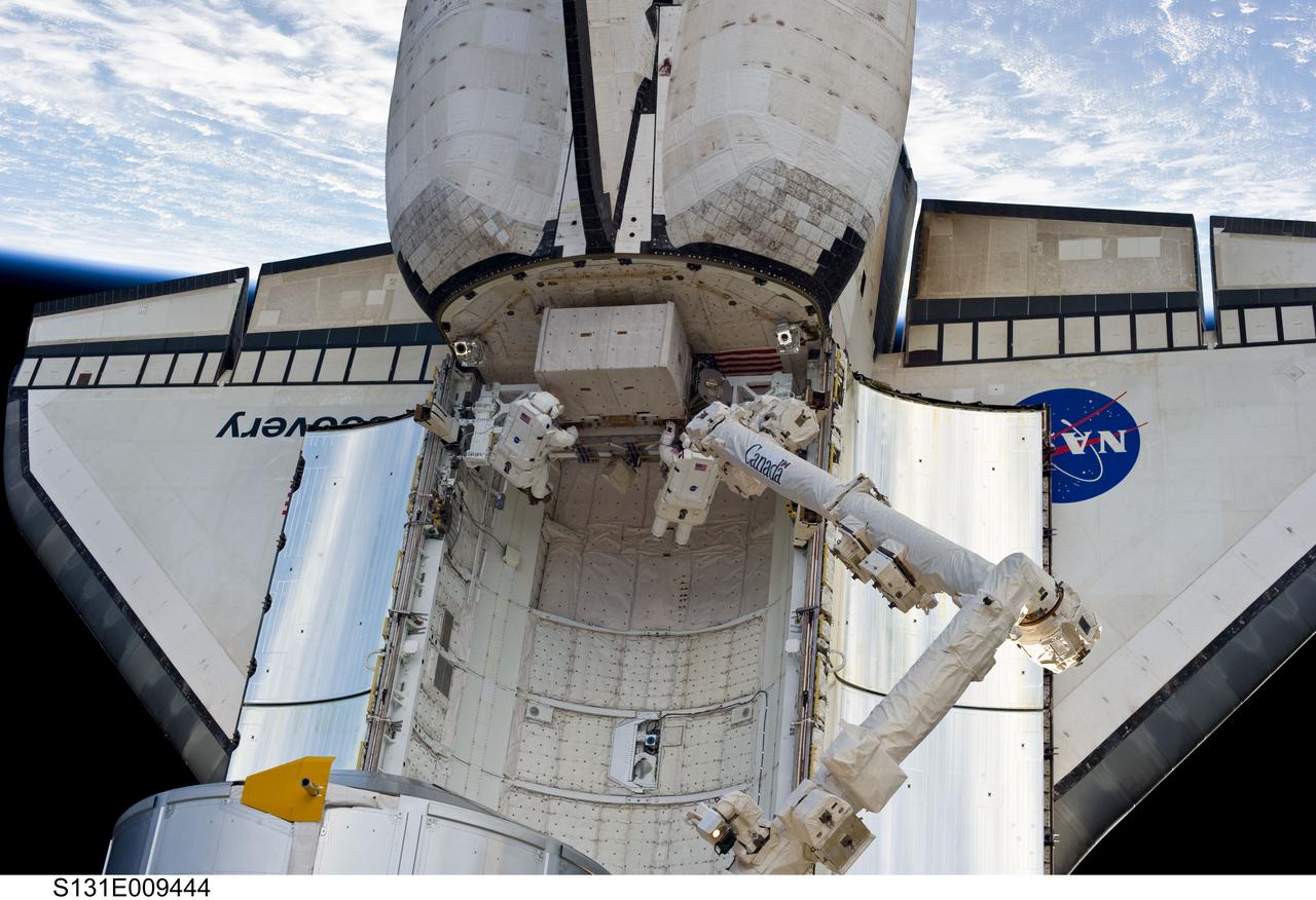S131-E-009444 (13 April 2010) --- Dwarfed by space shuttle Discovery, NASA astronauts Rick Mastracchio (right) and Clayton Anderson, both STS-131 mission specialists, are seen working in Discovery’s aft payload bay during the mission's third and final session of extravehicular activity (EVA) as construction and maintenance continue on the International Space Station. During the six-hour, 24-minute spacewalk, Mastracchio and Anderson hooked up fluid lines of the new 1,700-pound tank, retrieved some micrometeoroid shields from the Quest airlock’s exterior, relocated a portable foot restraint and prepared cables on the Zenith 1 truss for a spare Space to Ground Ku-Band antenna, two chores required before space shuttle Atlantis' STS-132/ULF-4 mission in May.