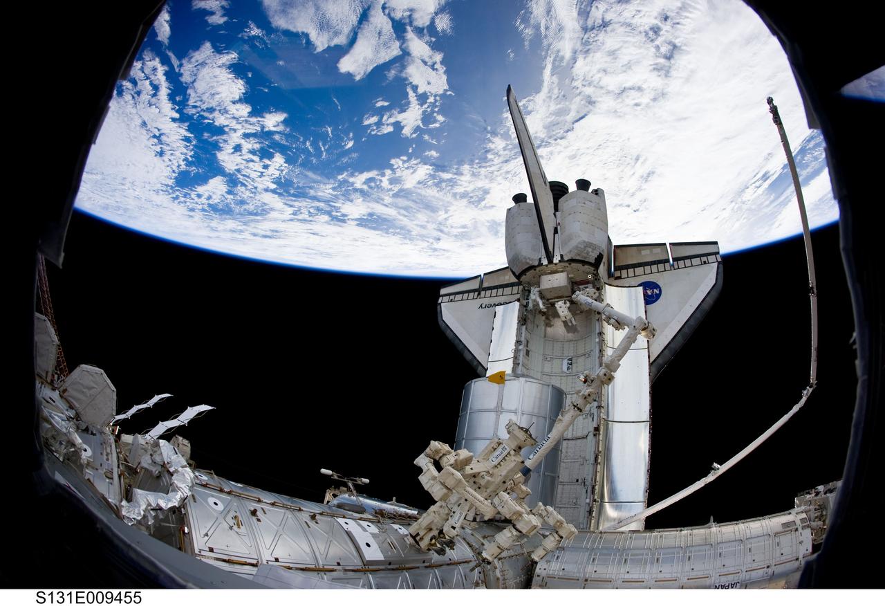 S131-E-009455 (13 April 2010) --- Dwarfed by space shuttle Discovery, NASA astronauts Rick Mastracchio (right) and Clayton Anderson, both STS-131 mission specialists, are seen working in Discovery’s aft payload bay during the mission's third and final session of extravehicular activity (EVA) as construction and maintenance continue on the International Space Station. During the six-hour, 24-minute spacewalk, Mastracchio and Anderson hooked up fluid lines of the new 1,700-pound tank, retrieved some micrometeoroid shields from the Quest airlock’s exterior, relocated a portable foot restraint and prepared cables on the Zenith 1 truss for a spare Space to Ground Ku-Band antenna, two chores required before space shuttle Atlantis' STS-132/ULF-4 mission in May. Earth’s horizon and the blackness of space provide the backdrop for the scene.