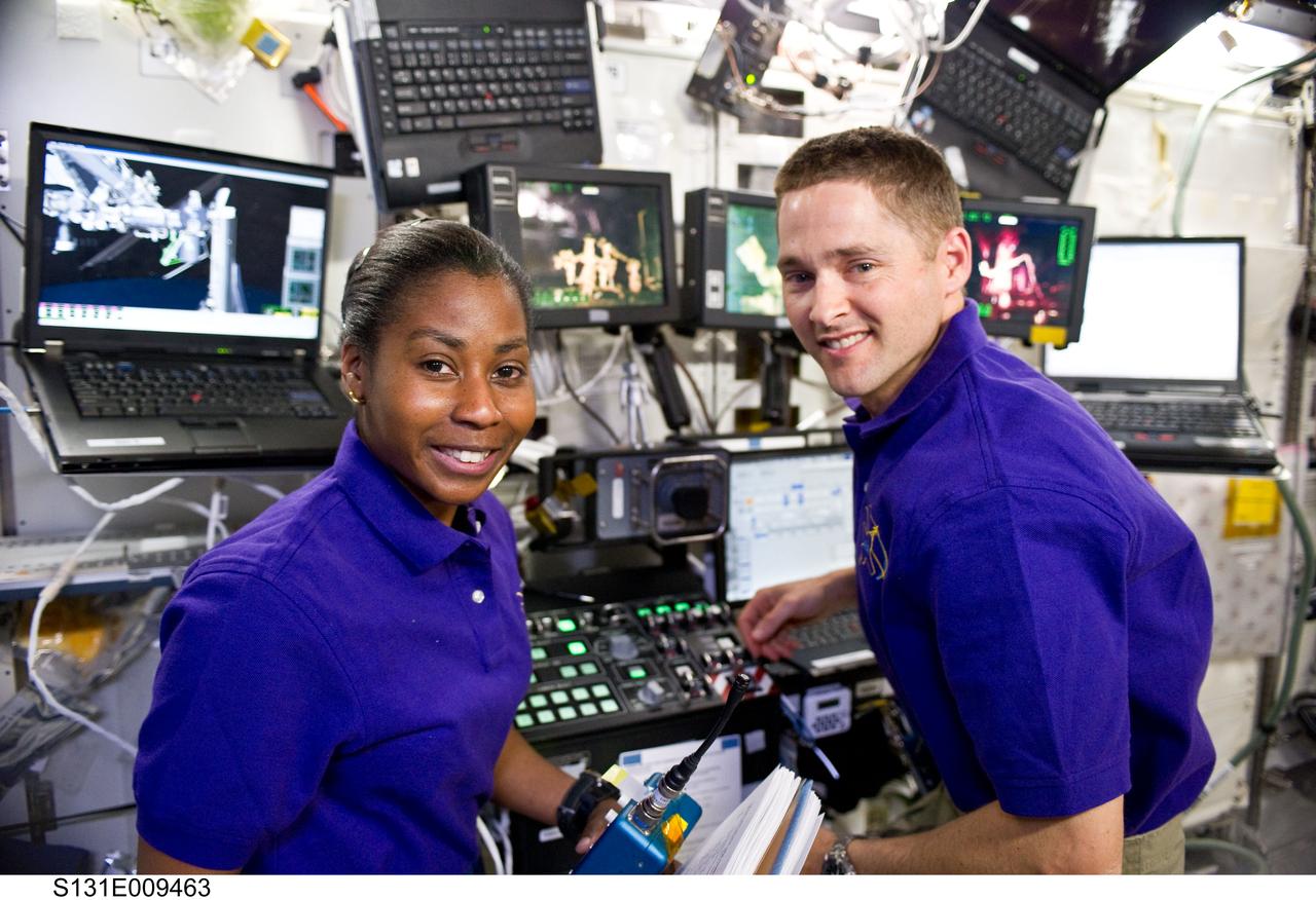 S131-E-009463 (13 April 2010) --- NASA astronauts James P. Dutton Jr., STS-131 pilot; and Stephanie Wilson, mission specialist, are pictured at a robotic workstation in the Destiny laboratory of the International Space Station while space shuttle Discovery remains docked with the station.