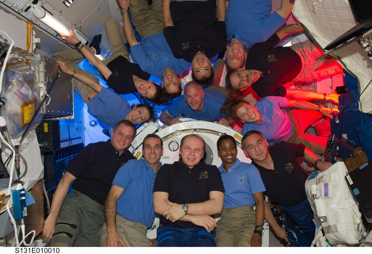 S131-E-010010 (14 April 2010) --- STS-131 and Expedition 23 crew members gather for a group portrait in the Kibo laboratory of the International Space Station while space shuttle Discovery remains docked with the station. STS-131 crew members pictured (light blue shirts) are NASA astronauts Alan Poindexter, commander; James P. Dutton Jr., pilot; Clayton Anderson, Rick Mastracchio, Dorothy Metcalf-Lindenburger, Stephanie Wilson and Japan Aerospace Exploration Agency astronaut Naoko Yamazaki, all mission specialists. Expedition 23 crew members pictured are Russian cosmonauts Oleg Kotov, commander; Mikhail Kornienko and Alexander Skvortsov; Japan Aerospace Exploration Agency astronaut Soichi Noguchi, and NASA astronauts T.J. Creamer and Tracy Caldwell Dyson, all flight engineers.