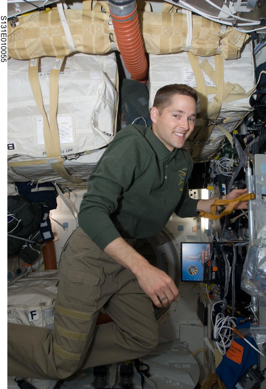 S131-E-010055 (14 April 2010) --- NASA astronaut James P. Dutton Jr., STS-131 pilot, is pictured on the middeck of space shuttle Discovery while docked with the International Space Station.