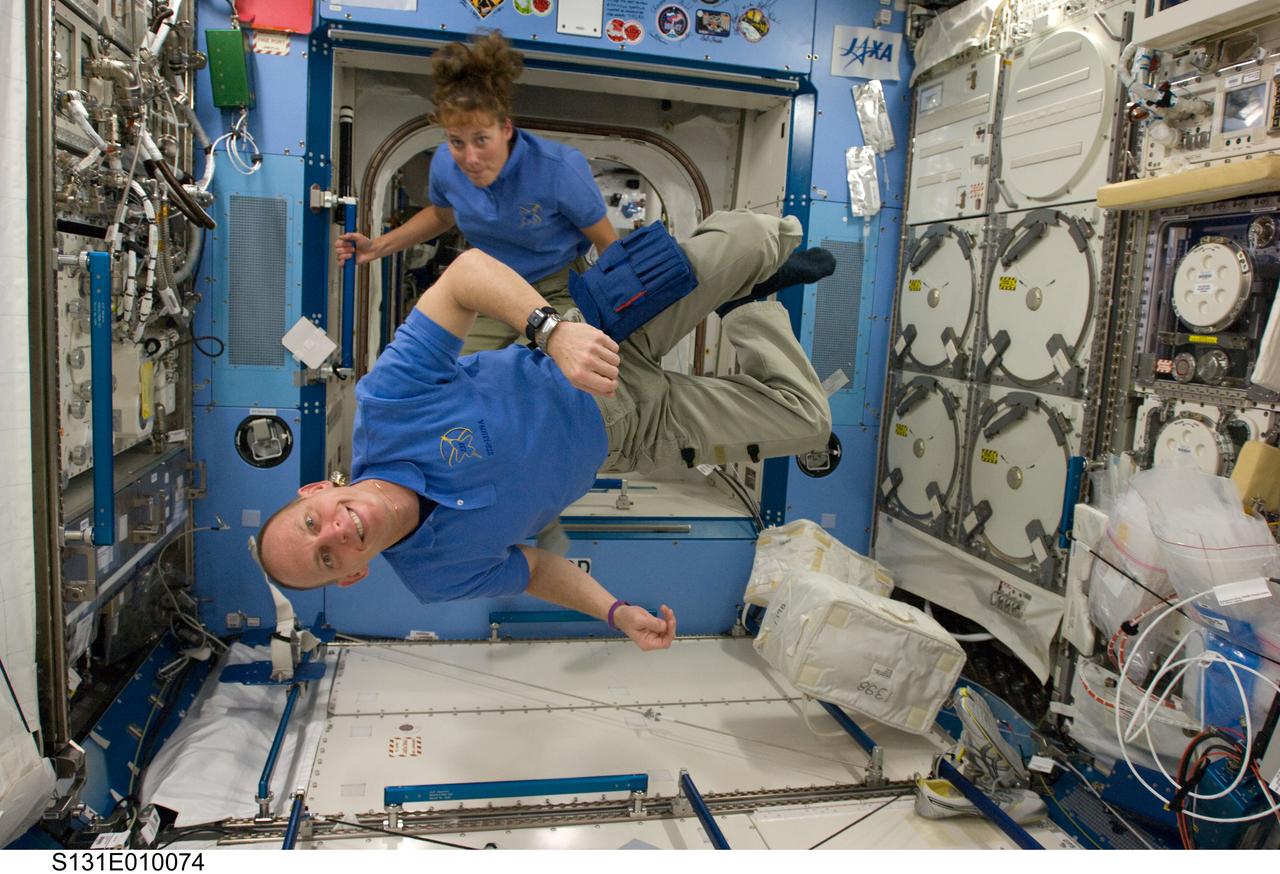 S131-E-010074 (14 April 2010) --- NASA astronauts Clayton Anderson and Dorothy Metcalf-Lindenburger, both STS-131 mission specialists, are pictured in the Kibo laboratory of the International Space Station while space shuttle Discovery remains docked with the station.