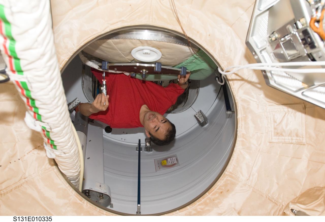 S131-E-010335 (16 April 2010) --- Japan Aerospace Exploration Agency (JAXA) astronaut Soichi Noguchi, Expedition 23 flight engineer, works to relocate a reflective element on the PMA-2 docking target in support of the Sensor Test for Orion Relative Navigation Risk Mitigation (STORRM) on the International Space Station while space shuttle Discovery (STS-131) remains docked with the station.