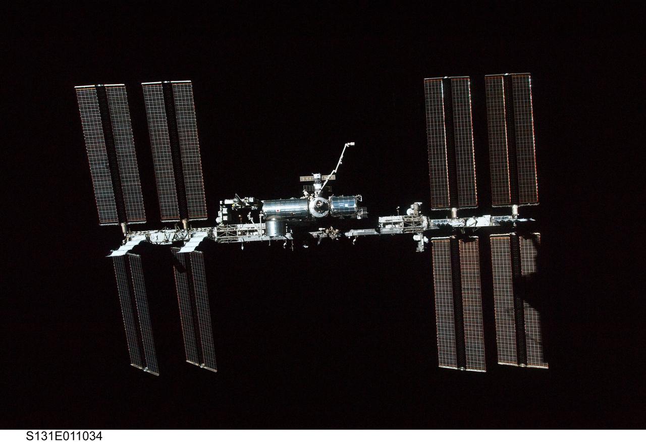 S131-E-011034 (17 April 2010) --- Backdropped by the blackness of space, the International Space Station is featured in this image photographed by an STS-131 crew member on space shuttle Discovery after the station and shuttle began their post-undocking relative separation. Undocking of the two spacecraft occurred at 7:52 a.m. (CDT) on April 17, 2010. A partial shadow of Discovery is visible on the solar array wing panels at lower right.
