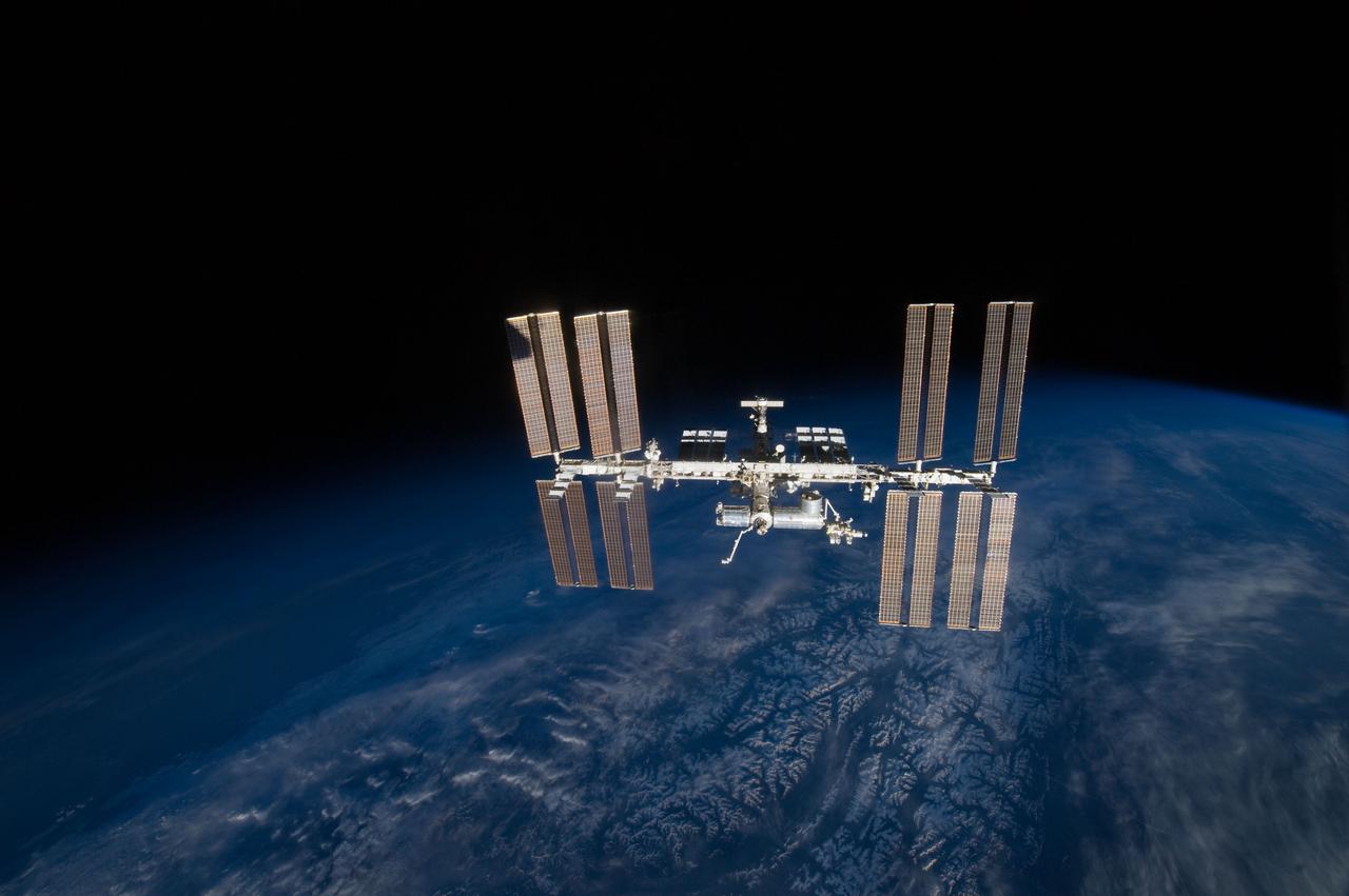 S131-E-011050 (17 April 2010) --- Backdropped by Earth’s horizon and the blackness of space, the International Space Station is featured in this image photographed by an STS-131 crew member on space shuttle Discovery after the station and shuttle began their post-undocking relative separation. Undocking of the two spacecraft occurred at 7:52 a.m. (CDT) on April 17, 2010.