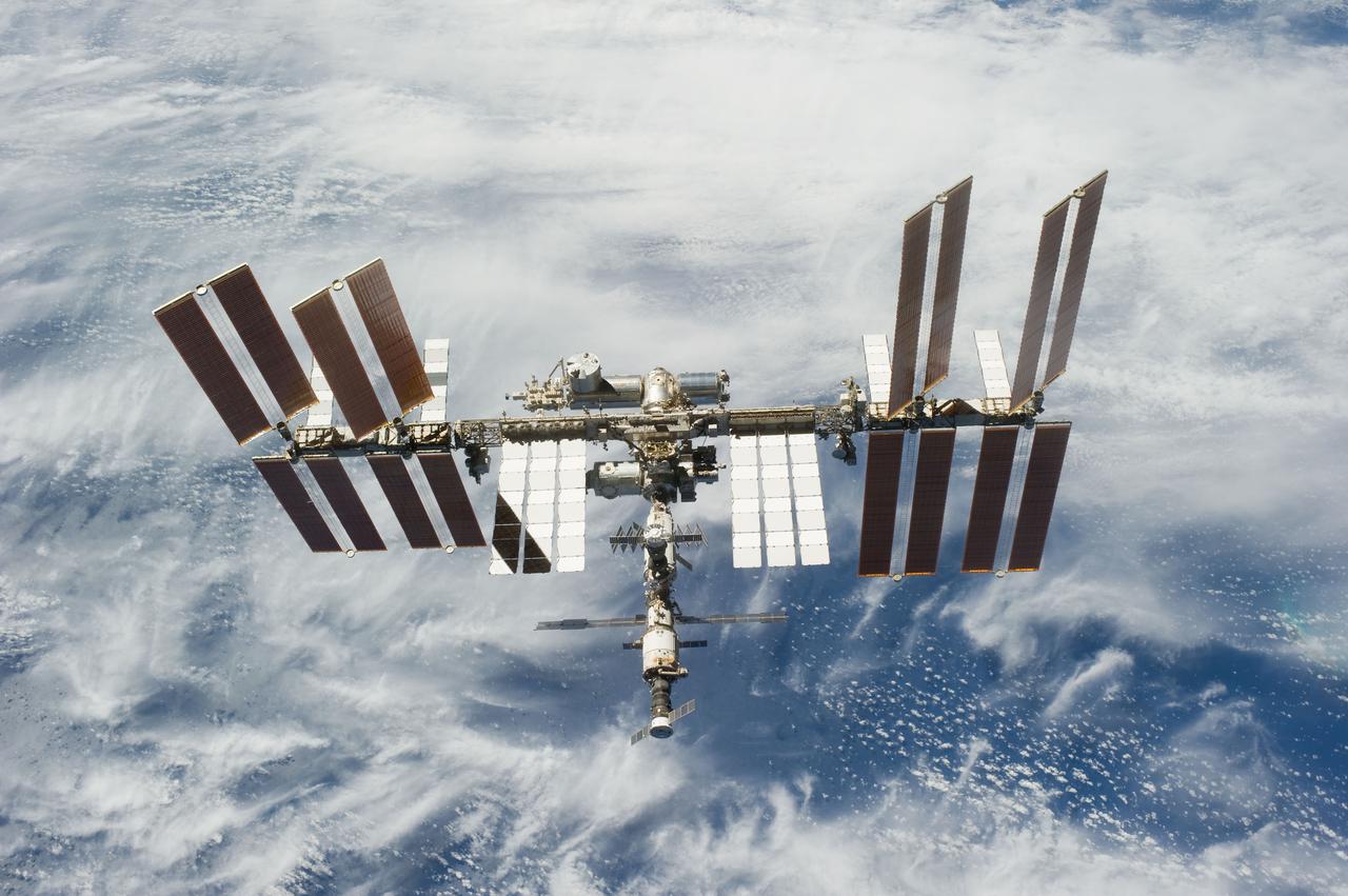 S131-E-011068 (17 April 2010) --- Backdropped by a blue and white part of Earth, the International Space Station is featured in this image photographed by an STS-131 crew member on space shuttle Discovery after the station and shuttle began their post-undocking relative separation. Undocking of the two spacecraft occurred at 7:52 a.m. (CDT) on April 17, 2010.