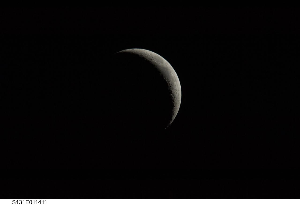 S131-E-011411 (18 April 2010) --- A crescent last quarter moon is featured in this image photographed by an STS-131 crew member on the Earth-orbiting space shuttle Discovery.