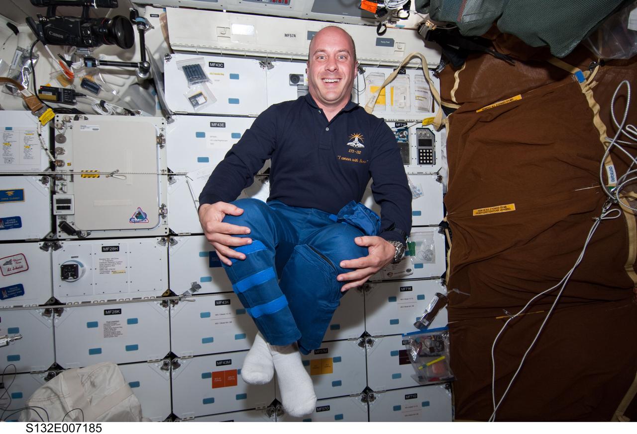 S132-E-007185 (15 May 2010) --- NASA astronaut Garrett Reisman, STS-132 mission specialist, takes advantage of the weightless environment on the middeck of the Earth-orbiting space shuttle Atlantis to get creative with his posture during Flight Day 2 activities. Photo credit: National Aeronautics and Space Administration