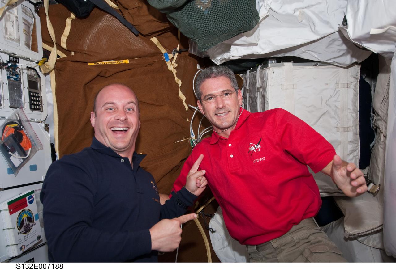 S132-E-007188 (15 May 2010) --- NASA astronauts Garrett Reisman (left) and Michael Good, both STS-132 mission specialists, are pictured on the middeck of space shuttle Atlantis during Flight Day 2 activities. Photo credit: National Aeronautics and Space Administration