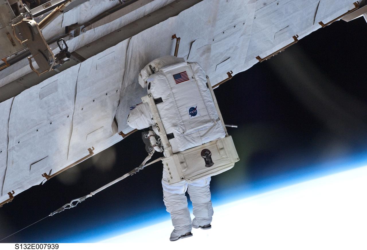 S132-E-007939 (17 May 2010) --- NASA astronaut Garrett Reisman, STS-132 mission specialist, participates in the mission's first session of extravehicular activity (EVA) as construction and maintenance continue on the International Space Station. During the seven-hour, 25-minute spacewalk, Reisman and NASA astronaut Steve Bowen (out of frame), mission specialist, loosened bolts holding six replacement batteries, installed a second antenna for high-speed Ku-band transmissions and adding a spare parts platform to Dextre, a two-armed extension for the station’s robotic arm.