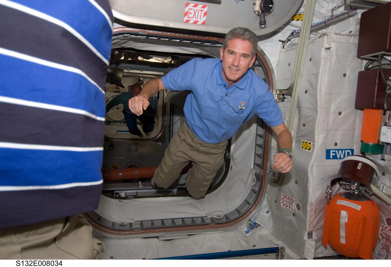 S132-E-008034 (16 May 2010) --- NASA astronaut Michael Good, STS-132 mission specialist, floats freely in the Columbus laboratory of the International Space Station while space shuttle Atlantis remains docked with the station.