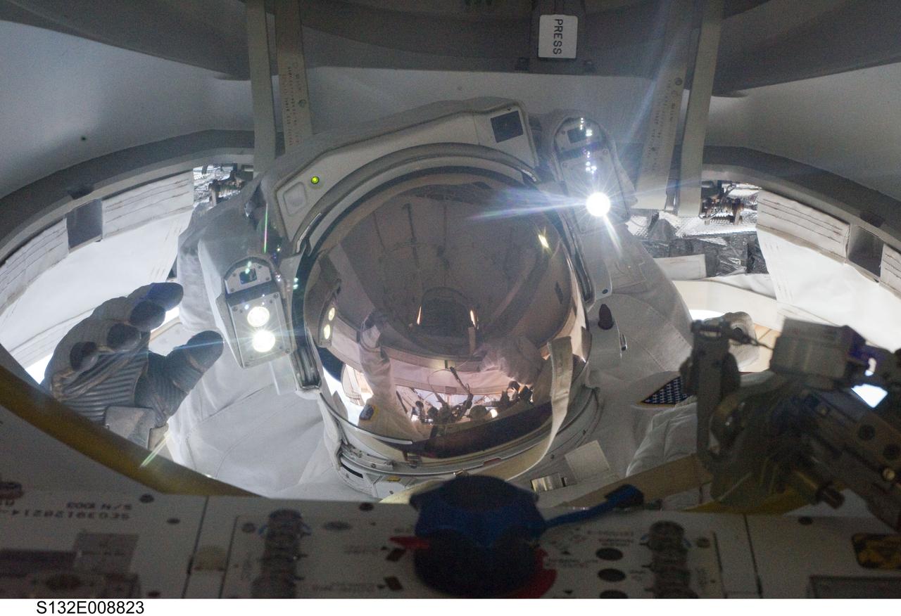 S132-E-008823 (19 May 2010) --- NASA astronaut Michael Good, STS-132 mission specialist, returns to the interior of the International Space Station through the Quest airlock as the mission’s second session of extravehicular activity (EVA) draws to a close.