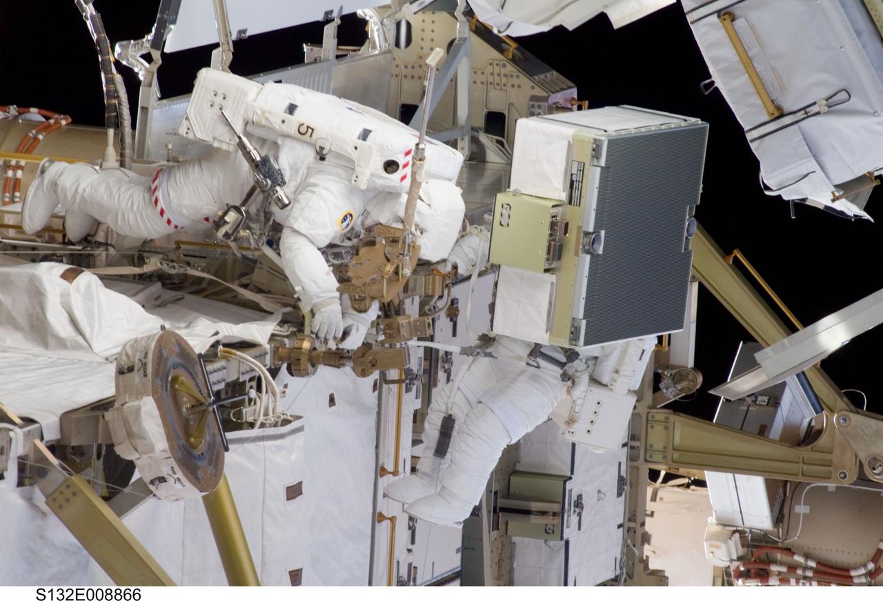 S132-E-008866 (21 May 2010) --- NASA astronauts Michael Good and Garrett Reisman (partially obscured), both STS-132 mission specialists, participate in the mission’s third and final session of extravehicular activity (EVA) as construction and maintenance continue on the International Space Station. During the six-hour, 46-minute spacewalk, Good and Reisman completed the installation of the final two of the six new batteries for the B side of the port 6 solar array. In addition, the astronauts installed a backup ammonia jumper cable between the port 4 and 5 trusses of the station, transferred a Power and Data Grapple Fixture from the shuttle to the station, and reconfigured some tools.