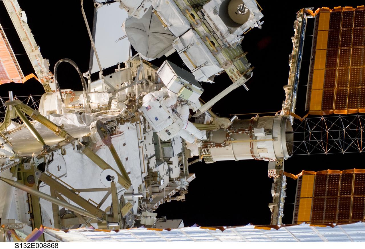 S132-E-008868 (21 May 2010) --- NASA astronauts Michael Good and Garrett Reisman (partially obscured), both STS-132 mission specialists, participate in the mission’s third and final session of extravehicular activity (EVA) as construction and maintenance continue on the International Space Station. During the six-hour, 46-minute spacewalk, Good and Reisman completed the installation of the final two of the six new batteries for the B side of the port 6 solar array. In addition, the astronauts installed a backup ammonia jumper cable between the port 4 and 5 trusses of the station, transferred a Power and Data Grapple Fixture from the shuttle to the station, and reconfigured some tools.