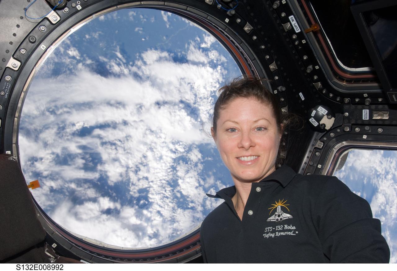 S132-E-008992 (21 May 2010) --- An STS-132 crewmember took this photograph of NASA astronaut Tracy Caldwell Dyson, Expedition 23 flight engineer, inside the International Space Station's  Cupola, a seven-windowed turret-like module on the orbital outpost.  This photo was taken while two of Atlantis' crew members were finishing STS-132's third and final session of extravehicular activity.  Photo credit: NASA or National Aeronautics and Space Administration