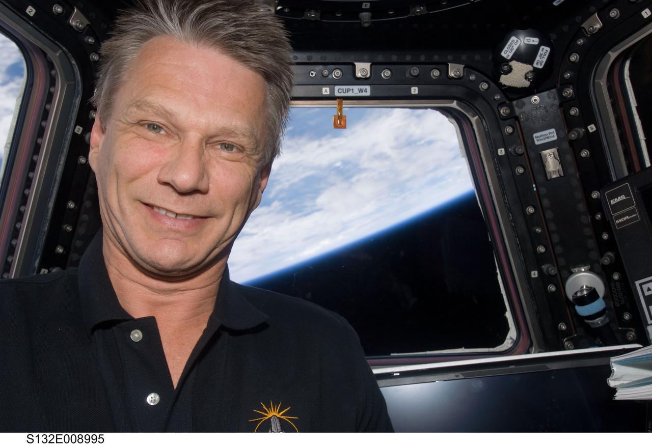 S132-E-008995 (21 May 2010) --- NASA astronaut Piers Sellers has been into space before the current STS-132 mission of space shuttle Atlantis. But this flight's visit to the International Space Station has afforded the mission specialist his first look at the Cupola and his first looks from the seven-windowed turret-like module on the orbital outpost. This photo was taken inside the Cupola while two of Sellers' crewmates were finishing STS-132's third and final session of extravehicular activity. Photo credit: NASA or National Aeronautics and Space Administration