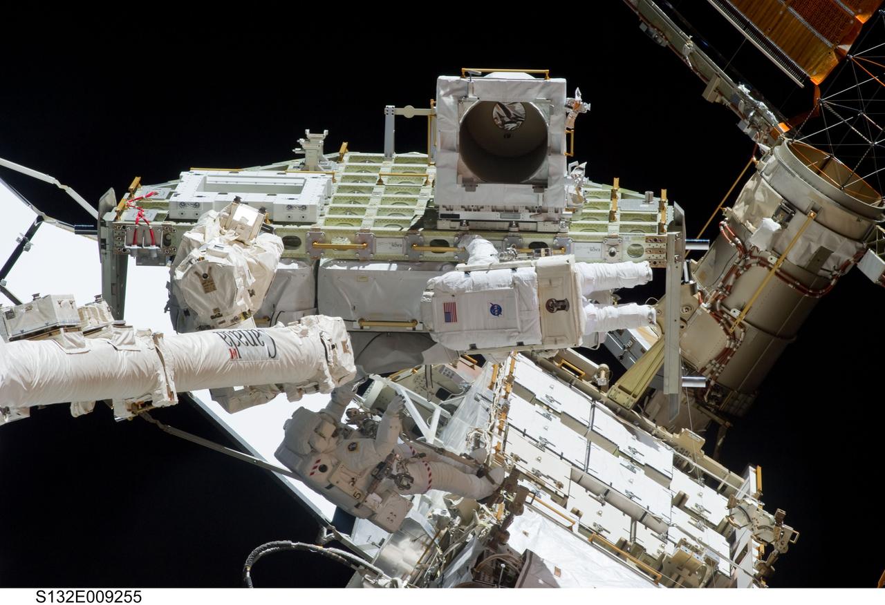 S132-E-009255 (21 May 2010) --- NASA astronauts Michael Good (bottom center) and Garrett Reisman, both STS-132 mission specialists, participate in the mission’s third and final session of extravehicular activity (EVA) as construction and maintenance continue on the International Space Station. During the six-hour, 46-minute spacewalk, Good and Reisman completed the installation of the final two of the six new batteries for the B side of the port 6 solar array. In addition, the astronauts installed a backup ammonia jumper cable between the port 4 and 5 trusses of the station, transferred a Power and Data Grapple Fixture from the shuttle to the station, and reconfigured some tools.