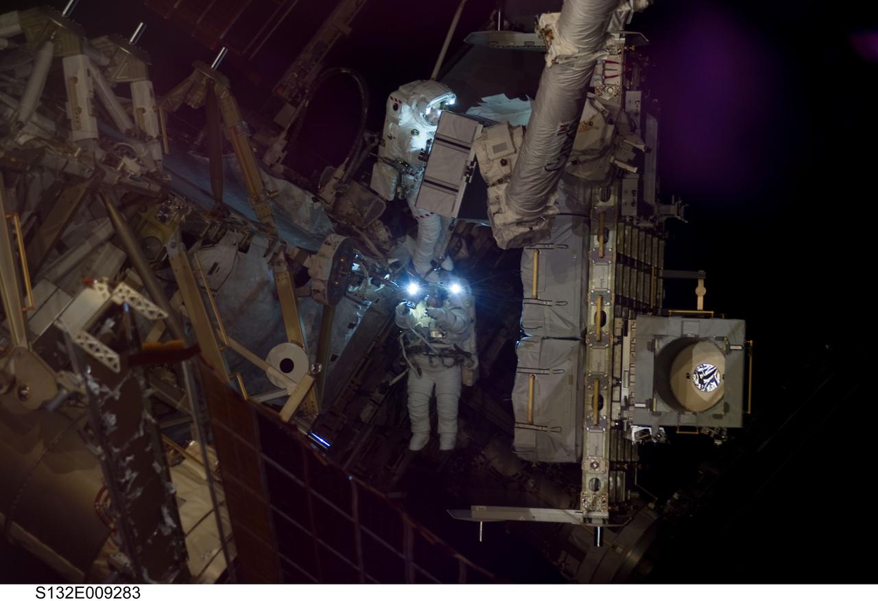 S132-E-009283 (21 May 2010) --- NASA astronauts Michael Good (top center) and Garrett Reisman, both STS-132 mission specialists, participate in the mission’s third and final session of extravehicular activity (EVA) as construction and maintenance continue on the International Space Station. During the six-hour, 46-minute spacewalk, Good and Reisman completed the installation of the final two of the six new batteries for the B side of the port 6 solar array. In addition, the astronauts installed a backup ammonia jumper cable between the port 4 and 5 trusses of the station, transferred a Power and Data Grapple Fixture from the shuttle to the station, and reconfigured some tools.