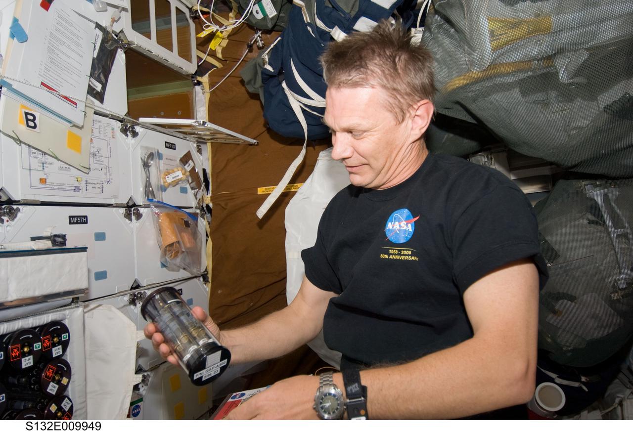 S132-E-009949 (22 May 2010) --- NASA astronaut Piers Sellers, STS-132 mission specialist, works with Group Activation Packs (GAP) on the middeck of space shuttle Atlantis while docked with the International Space Station.