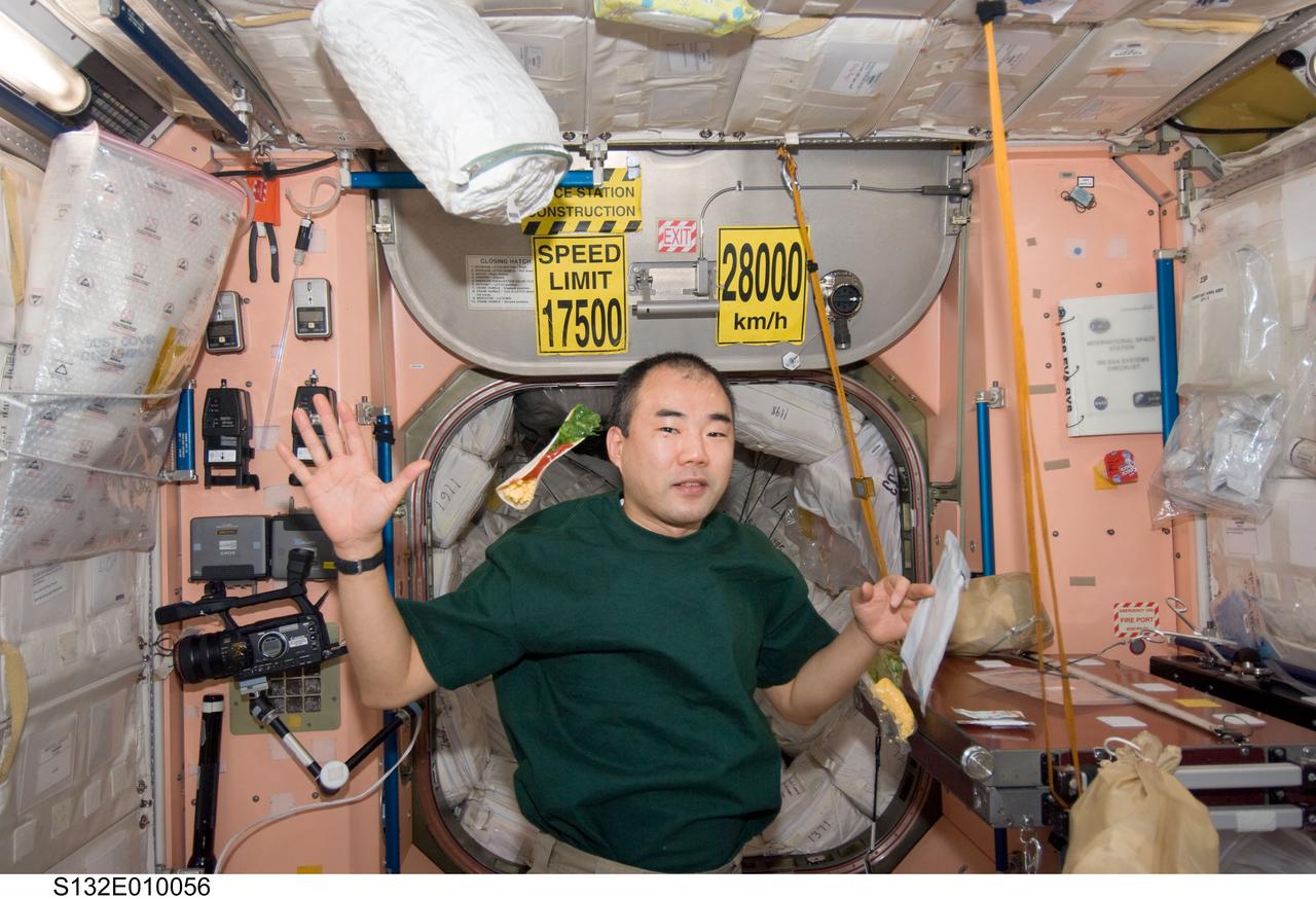 S132-E-010056 (23 May 2010) --- Japan Aerospace Exploration Agency (JAXA) astronaut Soichi Noguchi, Expedition 23 flight engineer, is pictured near a taco floating freely in the Unity node of the International Space Station while space shuttle Atlantis (STS-132) remains docked with the station.