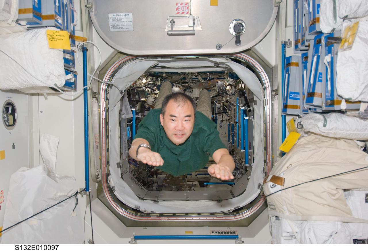 S132-E-010097 (23 May 2010) --- Japan Aerospace Exploration Agency (JAXA) astronaut Soichi Noguchi, Expedition 23 flight engineer, floats into the Unity node of the International Space Station while space shuttle Atlantis (STS-132) remains docked with the station.