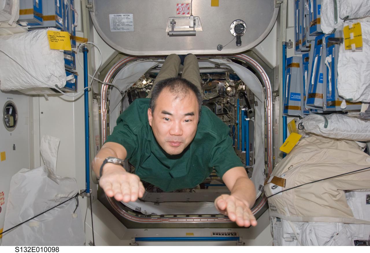 S132-E-010098 (23 May 2010) --- Japan Aerospace Exploration Agency (JAXA) astronaut Soichi Noguchi, Expedition 23 flight engineer, floats into the Unity node of the International Space Station while space shuttle Atlantis (STS-132) remains docked with the station.