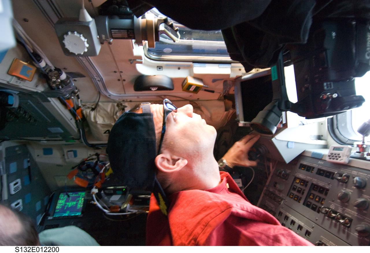 S132-E-012200 (23 May 2010) --- NASA astronaut Tony Antonelli, STS-132 pilot, looks through an overhead window on the aft flight deck of space shuttle Atlantis.