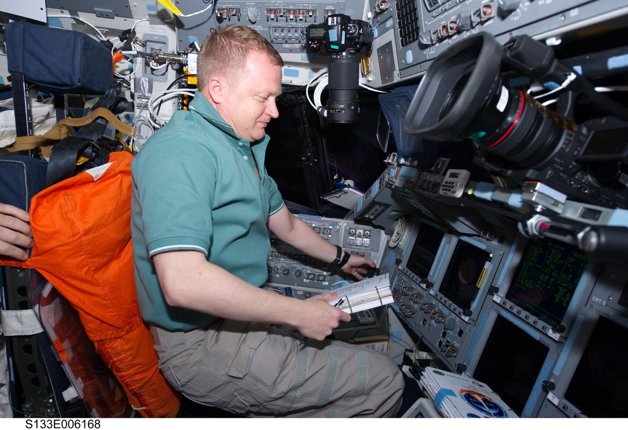 S133-E-006168 (25 Feb. 2011) --- NASA astronaut Eric Boe, STS-133 pilot, occupies the commander’s station on the flight deck of space shuttle Discovery during flight day two activities. Photo credit: NASA or National Aeronautics and Space Administration