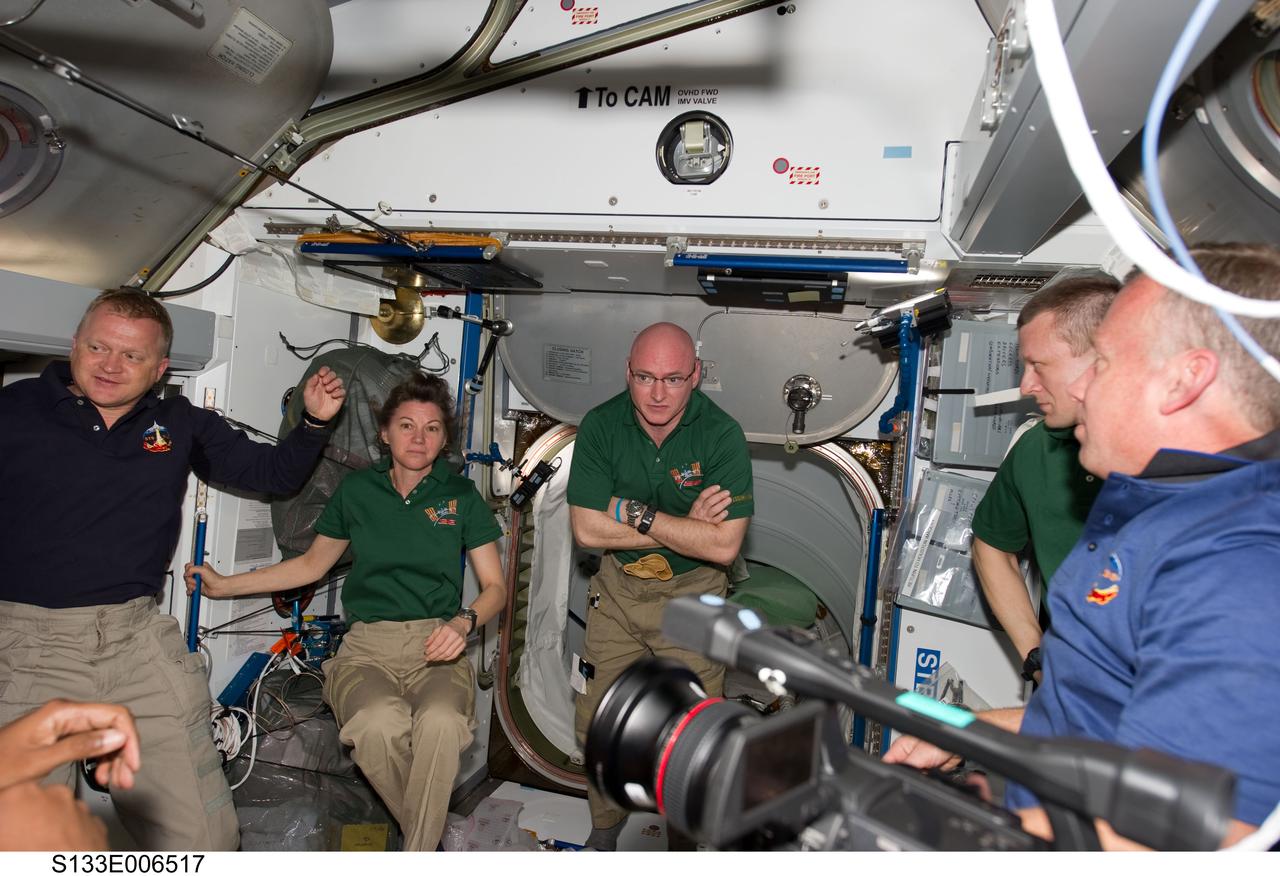 S133-E-006517 (26 Feb. 2011) --- STS-133 and Expedition 26 crew members are pictured in the Harmony node of the International Space Station shortly after space shuttle Discovery and the space station docked in space and the hatches were opened. Pictured from the left are NASA astronauts Eric Boe, STS-133 pilot; Catherine (Cady) Coleman, Expedition 26 flight engineer; Scott Kelly, Expedition 26 commander; Russian cosmonaut Dmitry Kondratyev, Expedition 26 flight engineer; and NASA astronaut Steve Lindsey, STS-133 commander. Photo credit: NASA or National Aeronautics and Space Administration