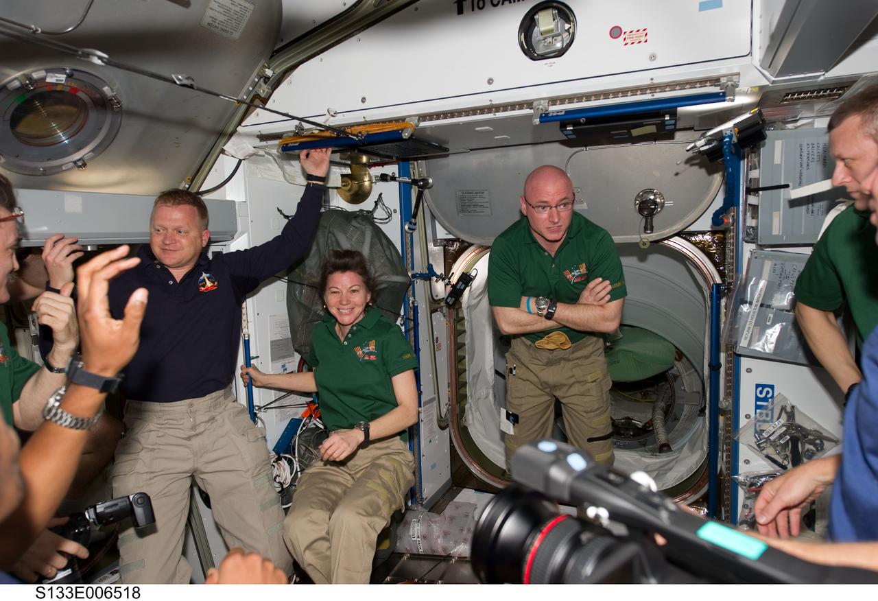 S133-E-006518 (26 Feb. 2011) --- STS-133 and Expedition 26 crew members are pictured in the Harmony node of the International Space Station shortly after space shuttle Discovery and the space station docked in space and the hatches were opened. Pictured from the left are NASA astronauts Eric Boe, STS-133 pilot; Catherine (Cady) Coleman, Expedition 26 flight engineer; Scott Kelly, Expedition 26 commander; and Russian cosmonaut Dmitry Kondratyev, Expedition 26 flight engineer. Photo credit: NASA or National Aeronautics and Space Administration