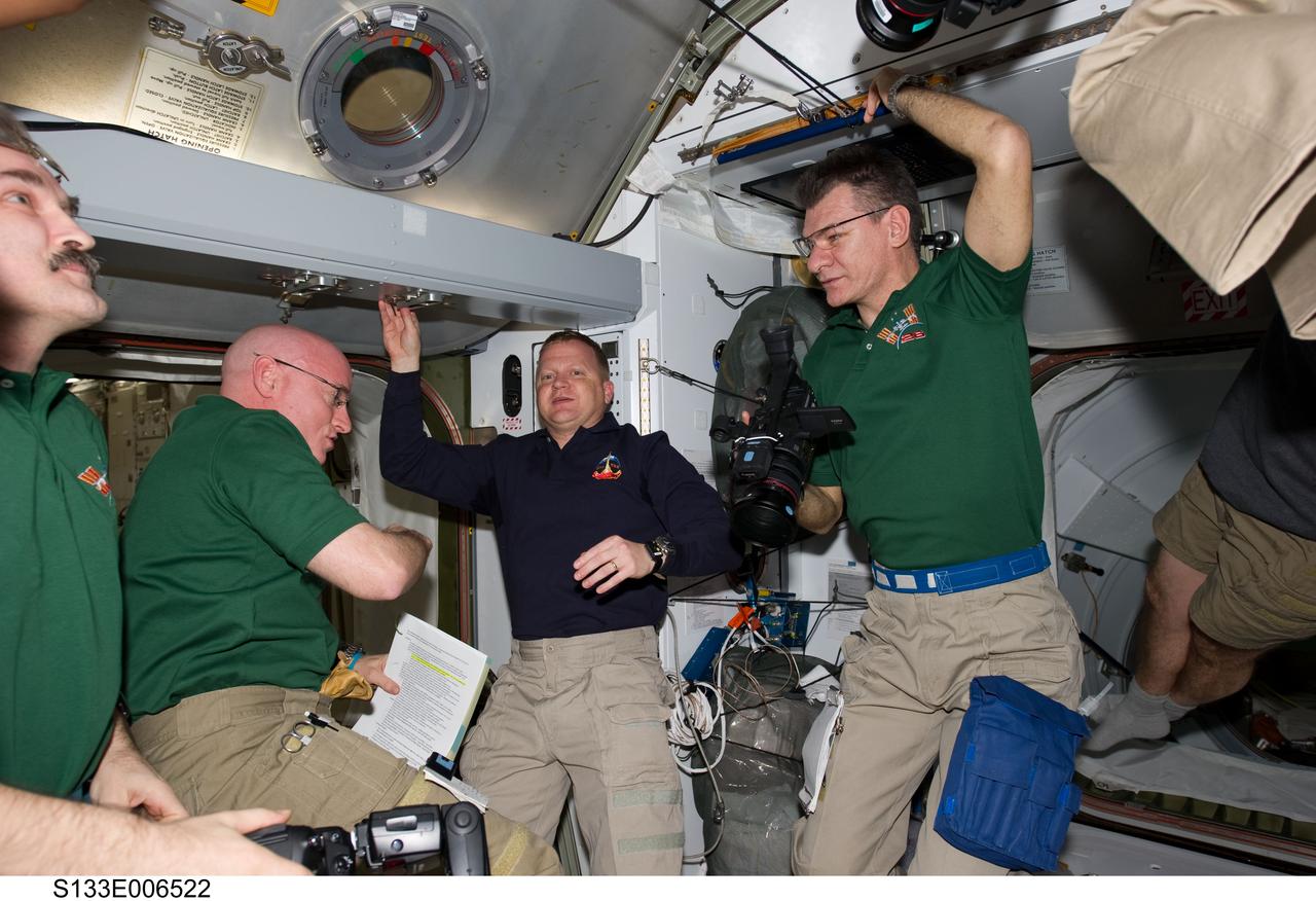 S133-E-006522 (26 Feb. 2011) --- STS-133 and Expedition 26 crew members are pictured in the Harmony node of the International Space Station shortly after space shuttle Discovery and the space station docked in space and the hatches were opened. Pictured from the left are Russian cosmonaut Alexander Kaleri, Expedition 26 flight engineer; NASA astronauts Scott Kelly, Expedition 26 commander; and Eric Boe, STS-133 pilot; along with European Space Agency astronaut Paolo Nespoli, Expedition 26 flight engineer. Photo credit: NASA or National Aeronautics and Space Administration